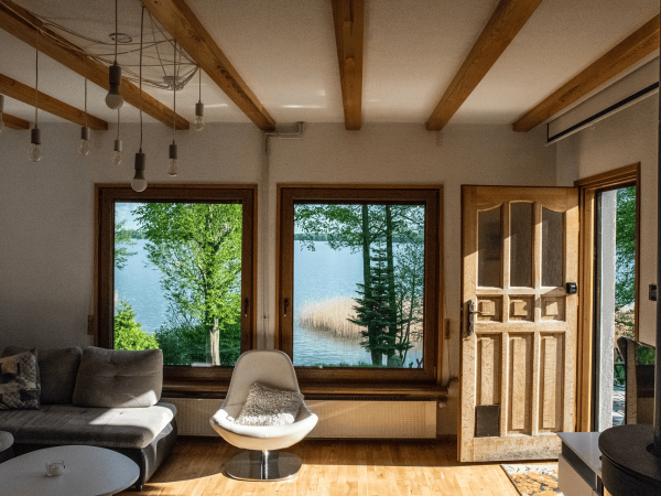 living-room-with-couch-chair-window-with-view-lake (1)
